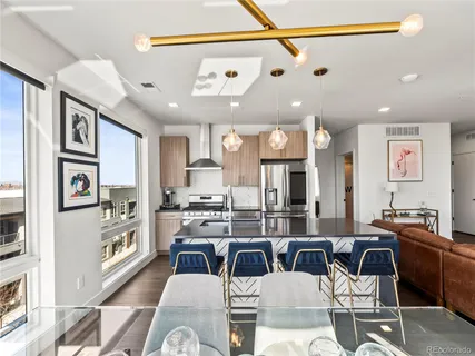 a kitchen with stainless steel appliances kitchen island granite countertop a stove and white cabinets