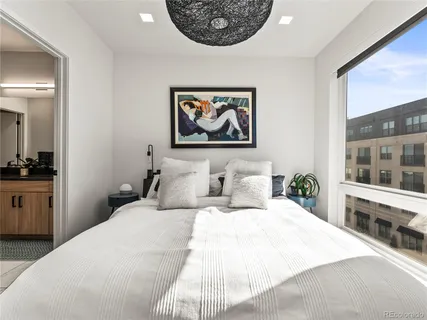 a bedroom with a large bed and a chandelier