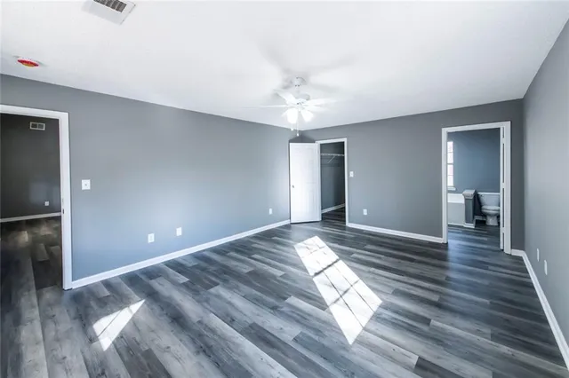 a view of empty room with wooden floor
