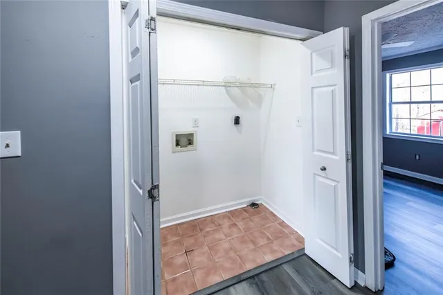 a view of a hallway with wooden floor and entryway