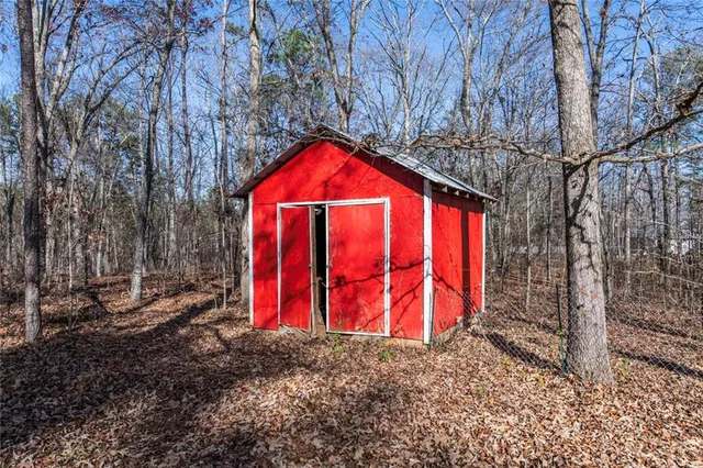 a view of a backyard with large trees