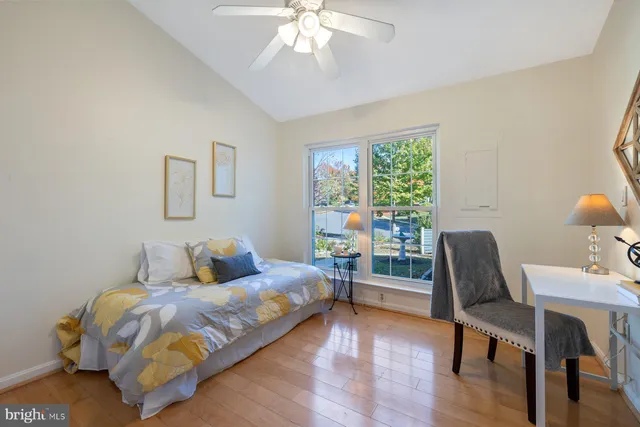 a bedroom with a bed mirror and a window