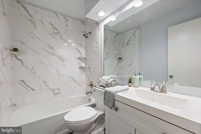 a bedroom with a bed a table and chair