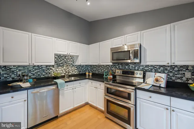 a living room with furniture a fireplace and a large window