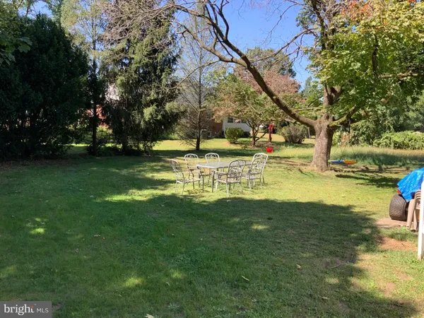 a view of a yard with swimming pool