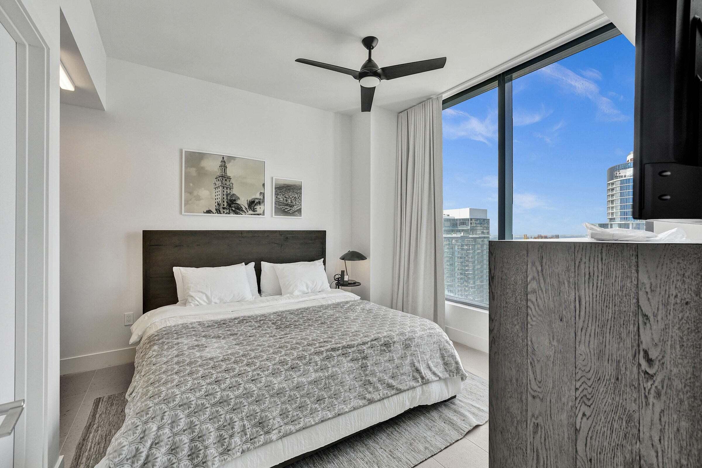 159 Northeast 6th Street, Unit 4813 Miami, FL 33132 - Photo 11 of 34 a bedroom with a large bed and a window