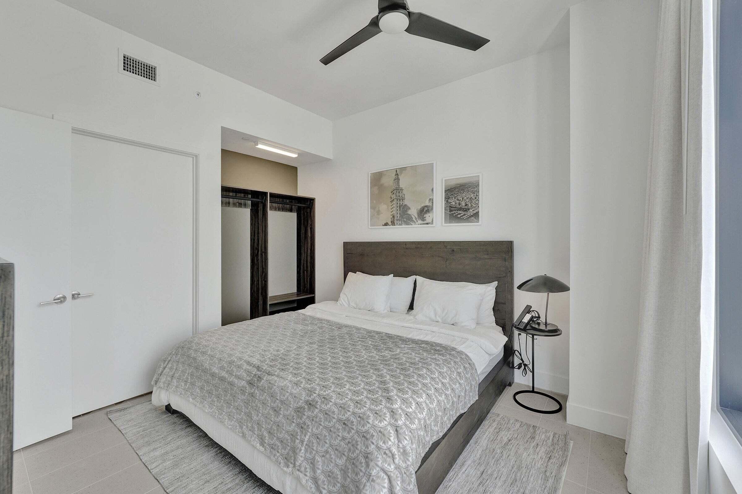 159 Northeast 6th Street, Unit 4813 Miami, FL 33132 - Photo 12 of 34 a bedroom with a bed and a night stand