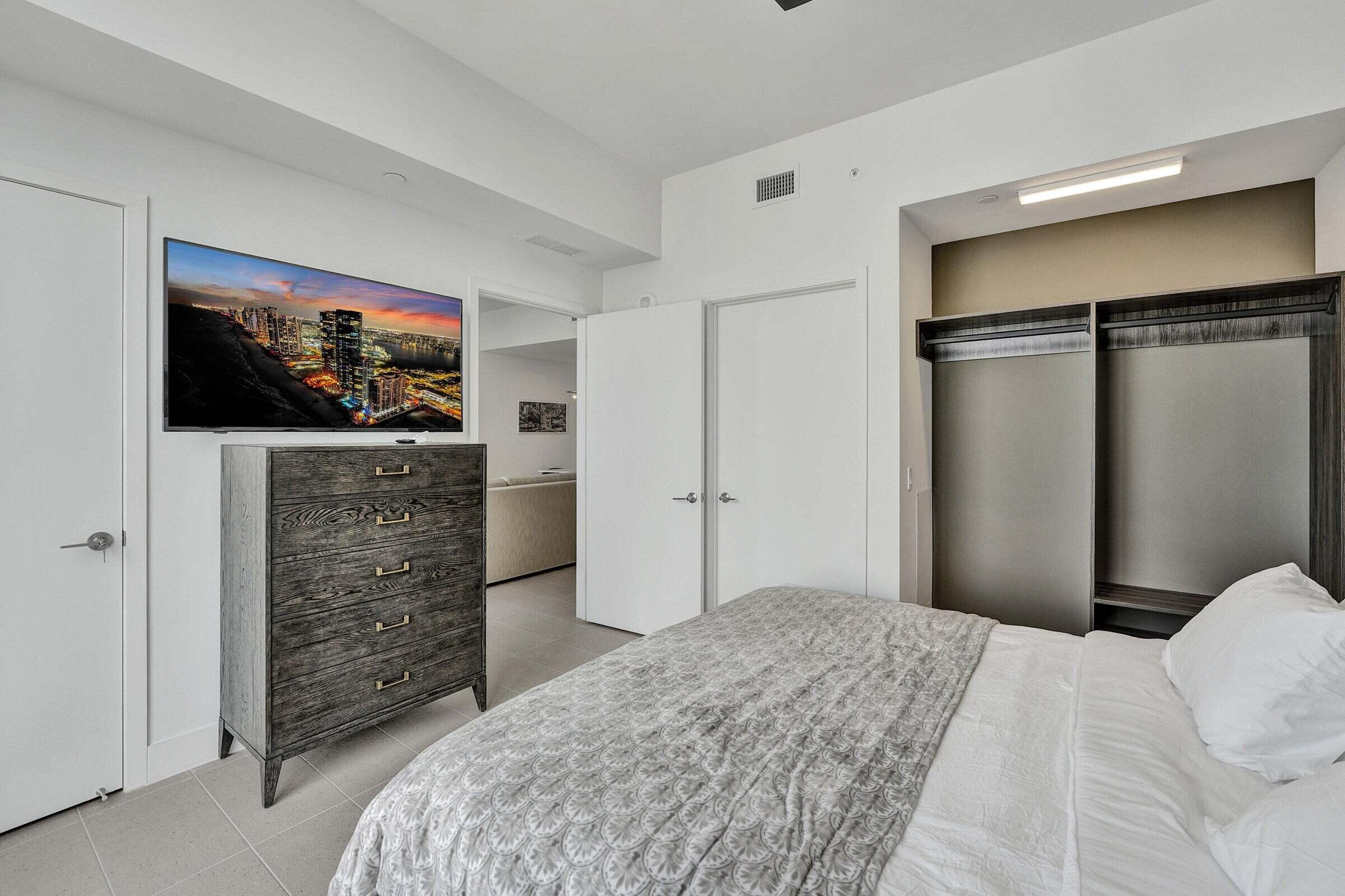 159 Northeast 6th Street, Unit 4813 Miami, FL 33132 - Photo 13 of 34 a bedroom with a bed and a flat screen tv