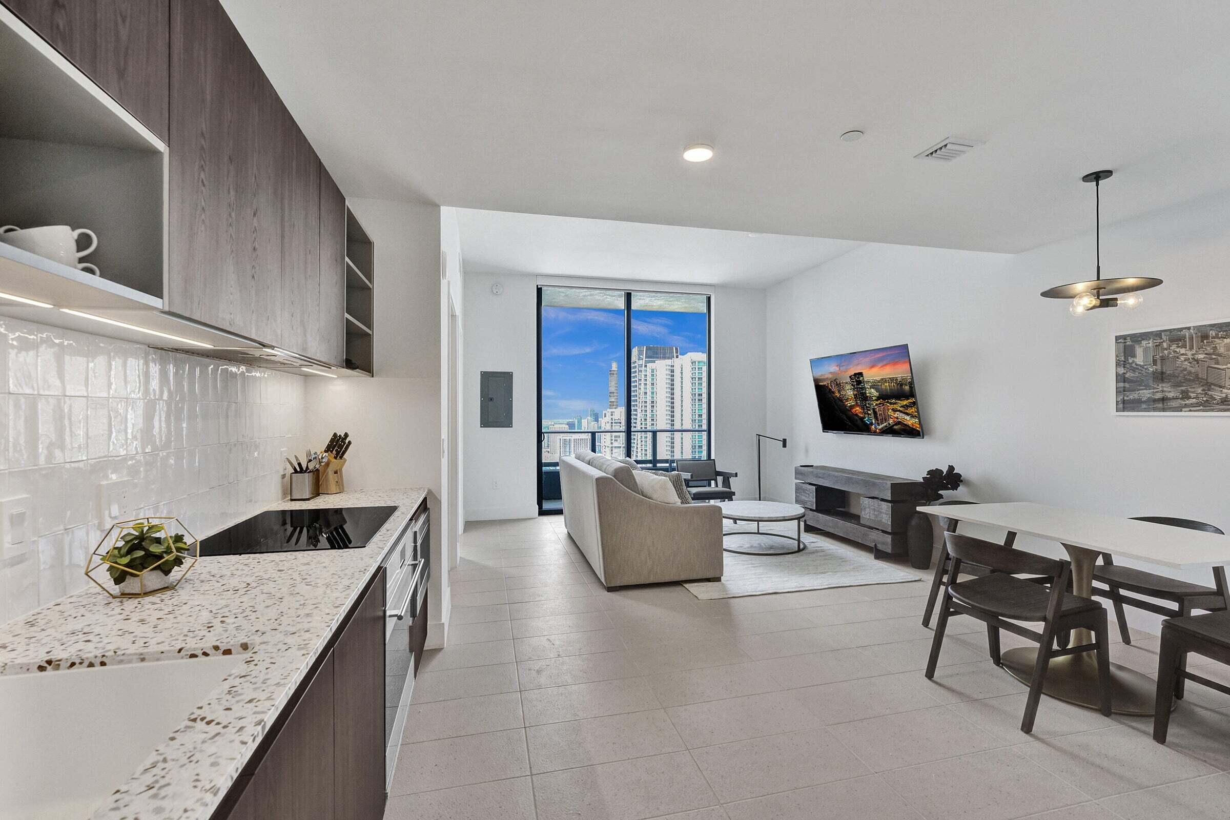 159 Northeast 6th Street, Unit 4813 Miami, FL 33132 - Photo 2 of 34 a kitchen with living room and furniture