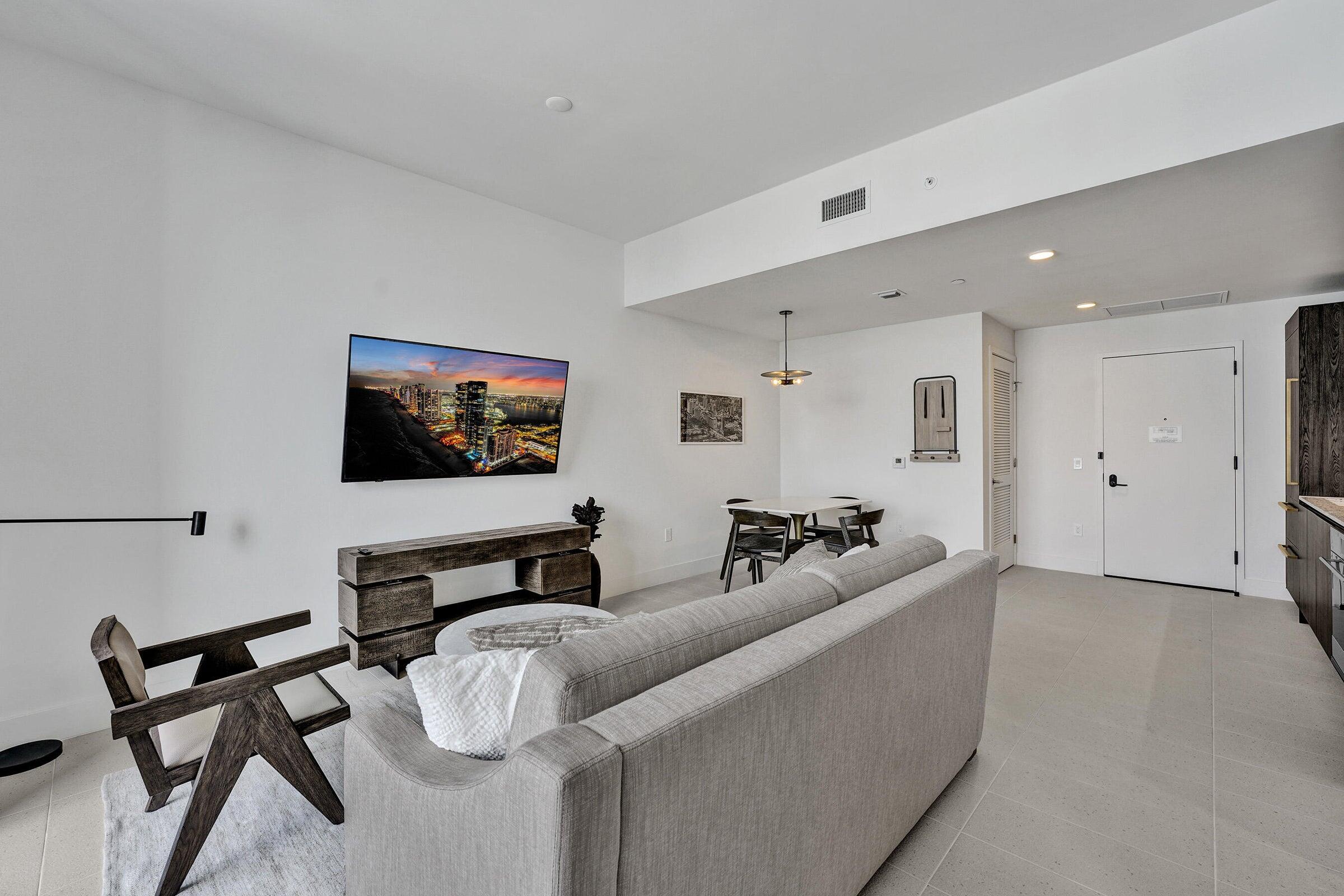 159 Northeast 6th Street, Unit 4813 Miami, FL 33132 - Photo 4 of 34 a living room with furniture and a flat screen tv