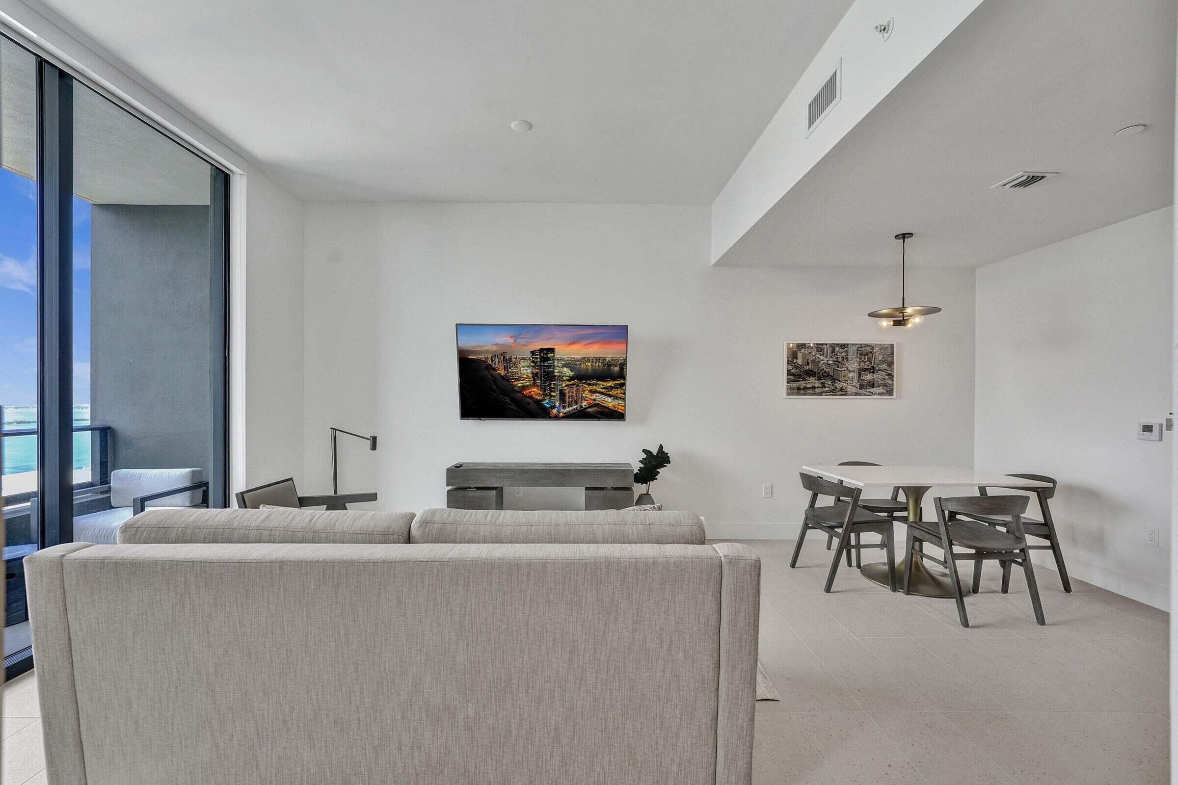 159 Northeast 6th Street, Unit 4813 Miami, FL 33132 - Photo 6 of 34 a living room with furniture and a flat screen tv