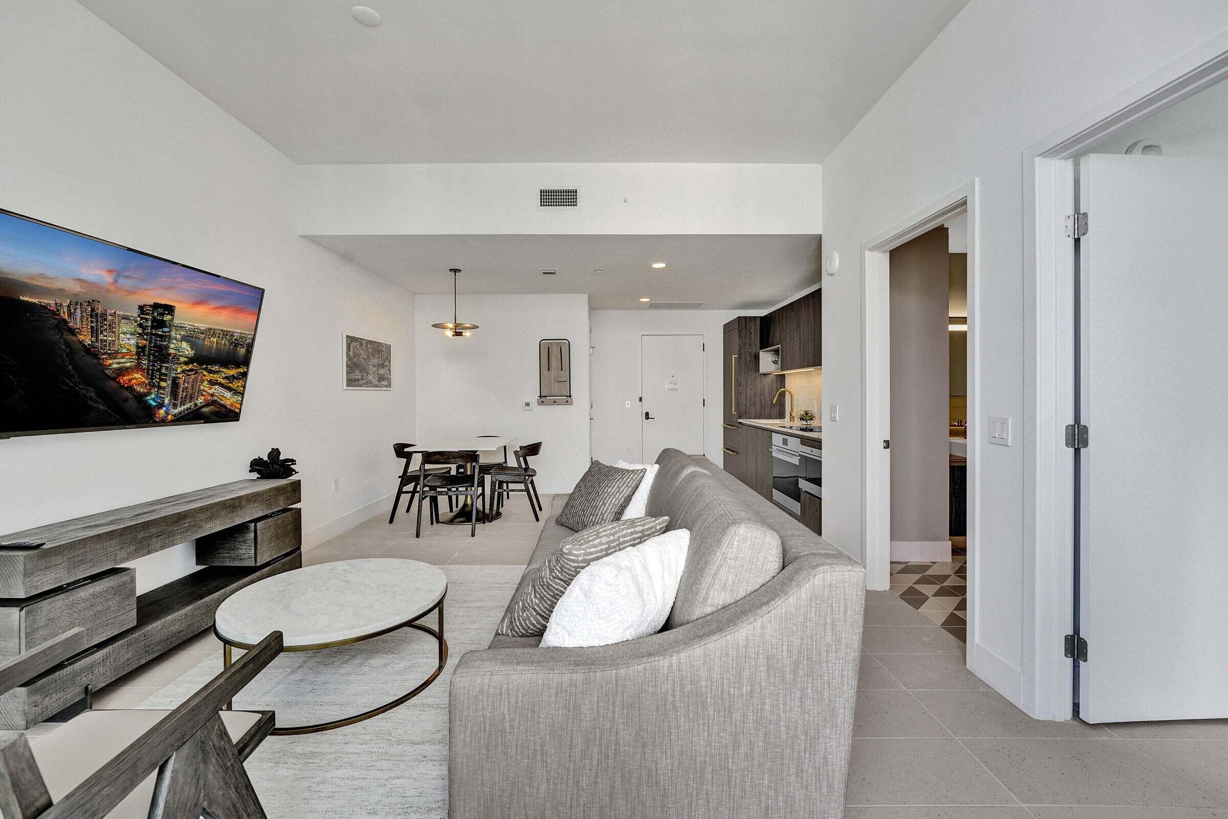 159 Northeast 6th Street, Unit 4813 Miami, FL 33132 - Photo 7 of 34 a living room with furniture and a flat screen tv