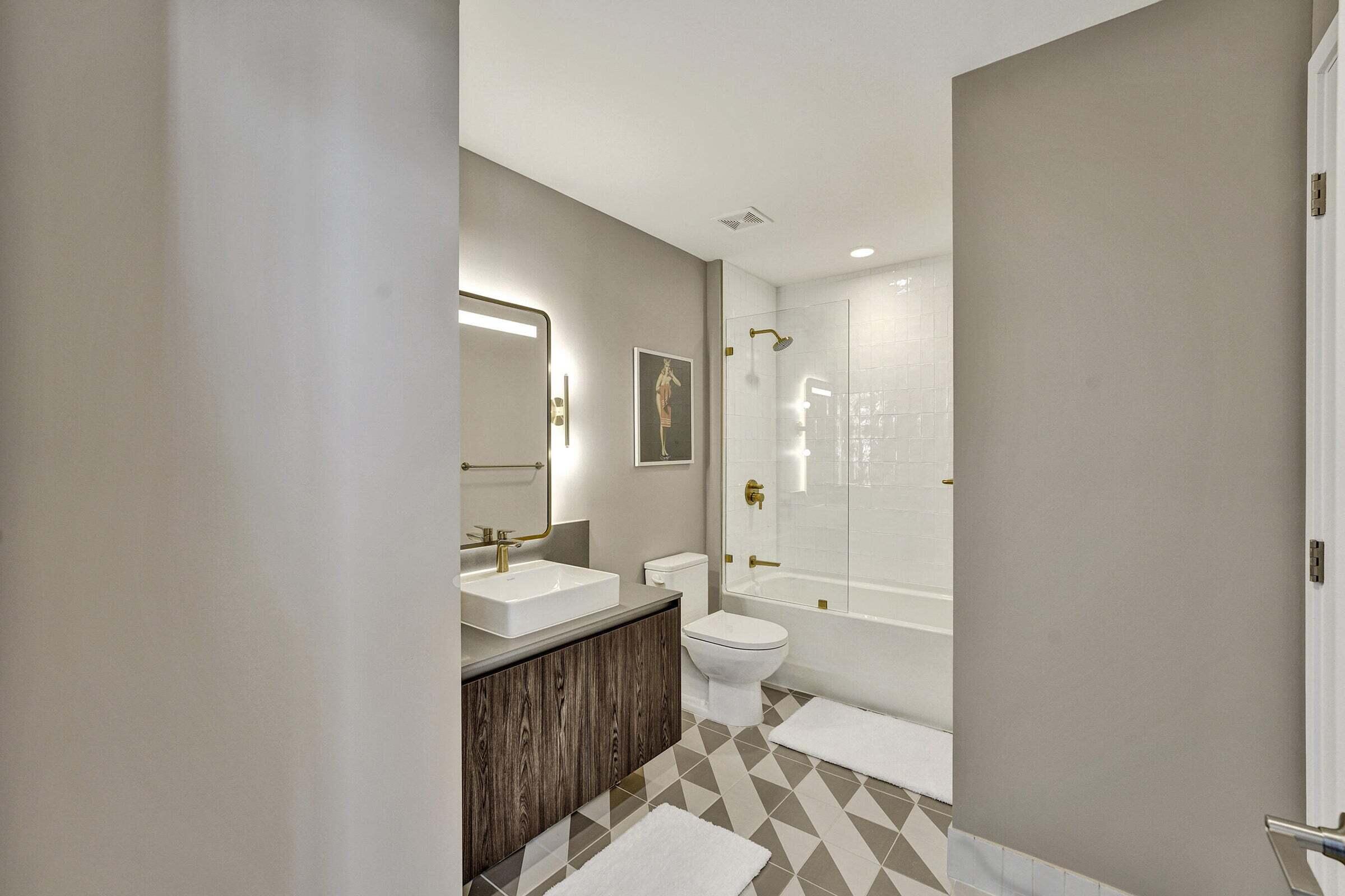 159 Northeast 6th Street, Unit 4813 Miami, FL 33132 - Photo 8 of 34 a bathroom with a sink a toilet and shower