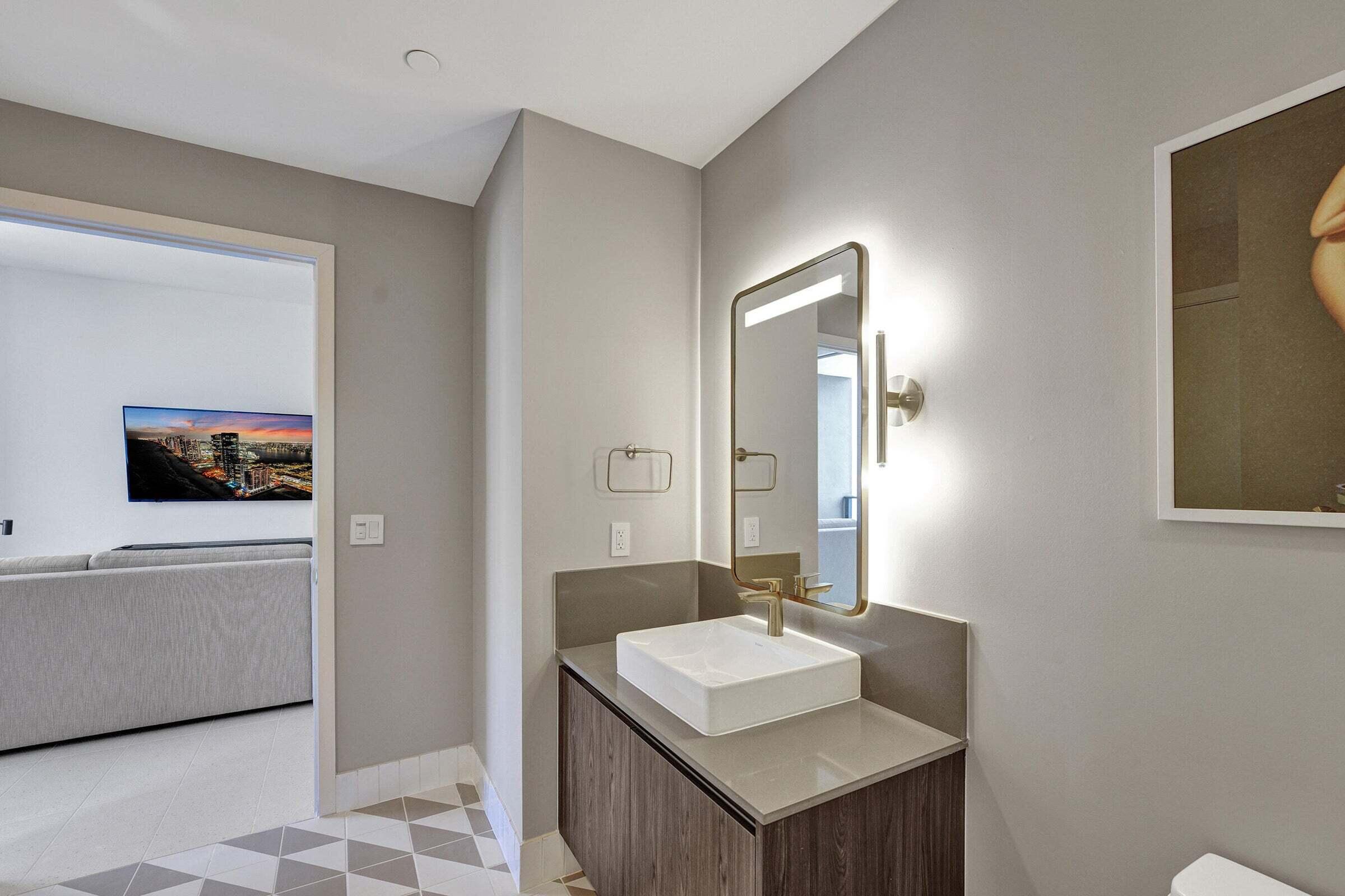 159 Northeast 6th Street, Unit 4813 Miami, FL 33132 - Photo 9 of 34 a bathroom with a sink and a mirror