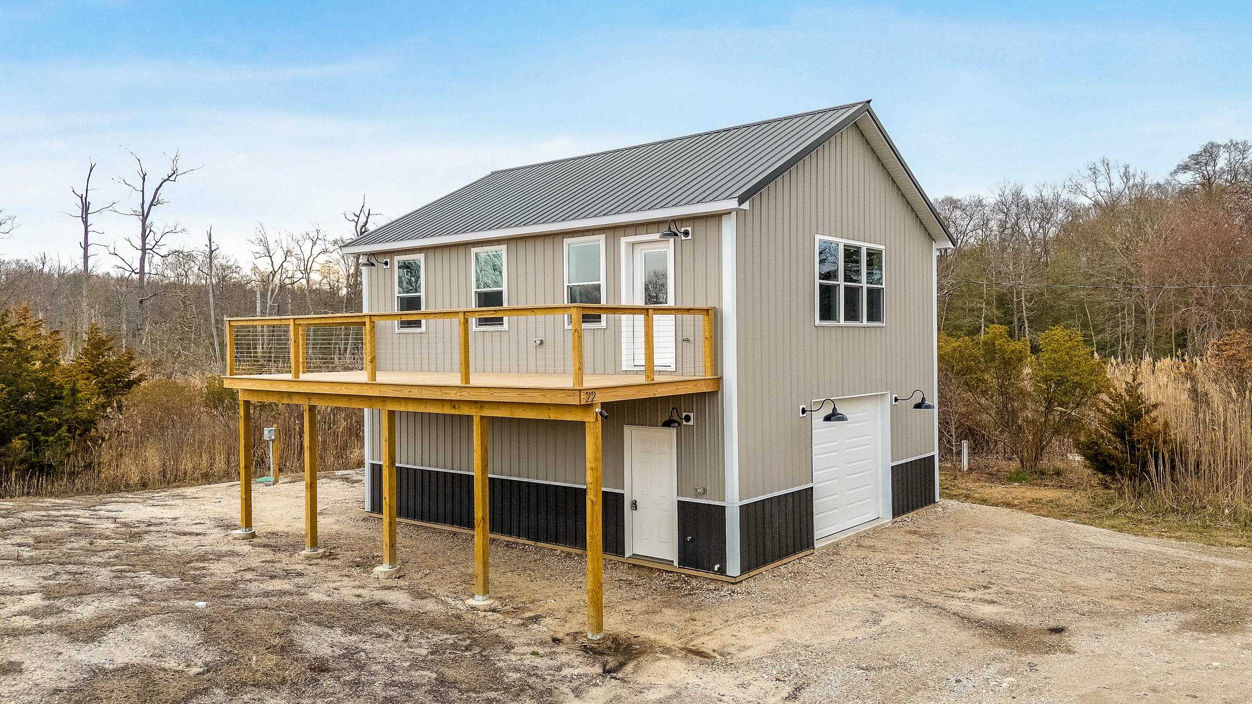 22 Moores Beach Road Delmont, NJ 08314 - Photo 1 of 18 a view of a house with a yard and garage