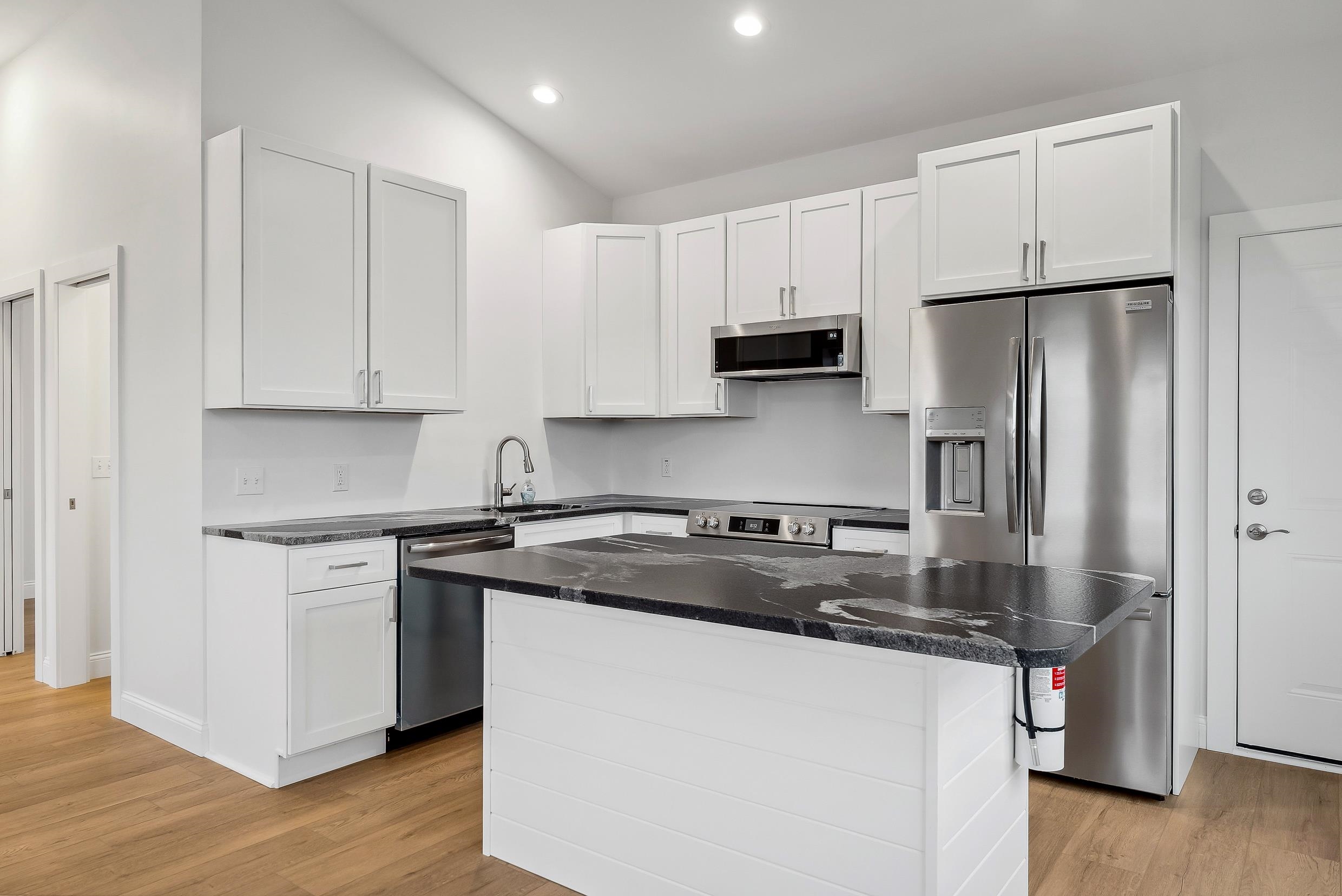 22 Moores Beach Road Delmont, NJ 08314 - Photo 3 of 18 a kitchen with stainless steel appliances granite countertop a stove a refrigerator a sink and white cabinets