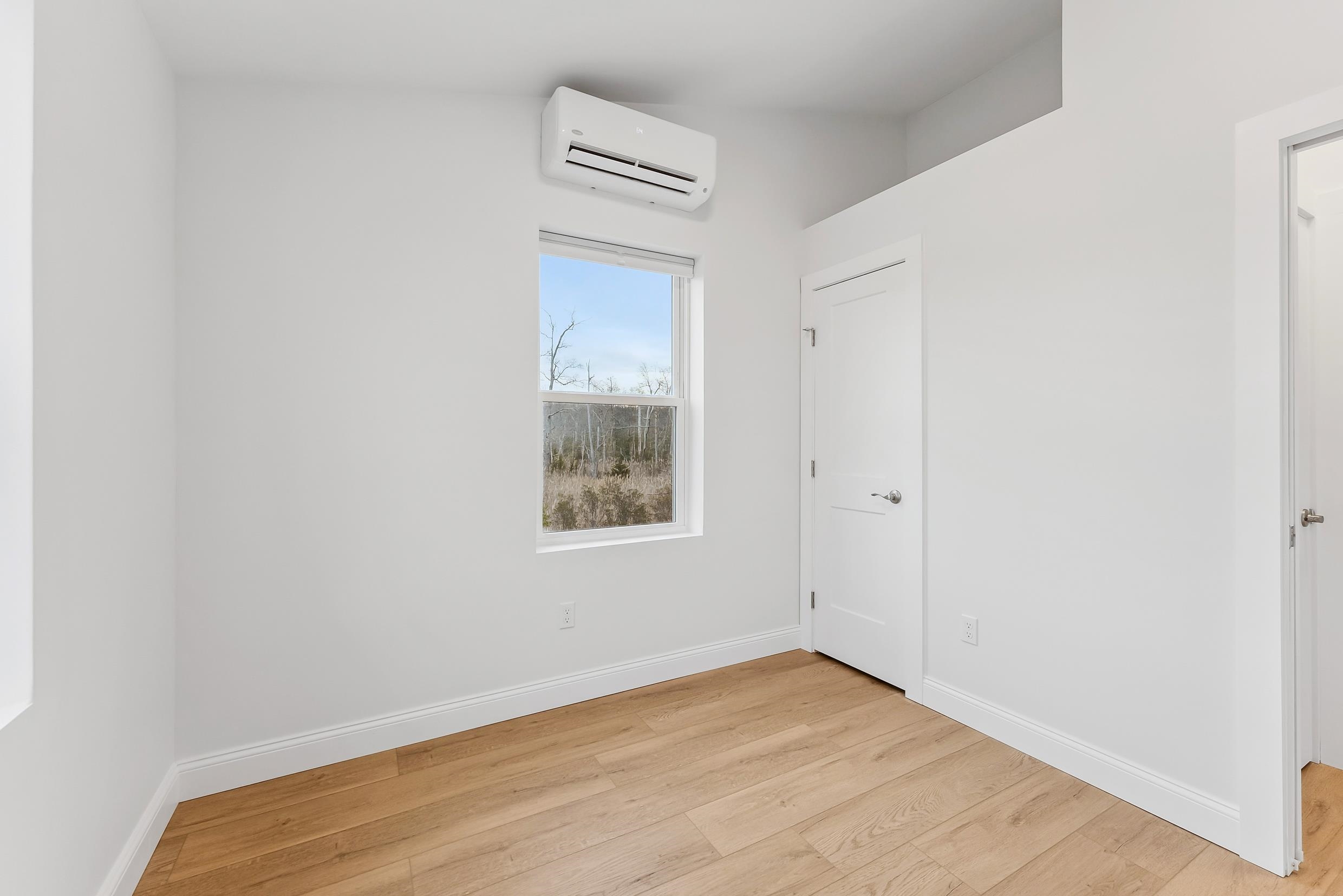 22 Moores Beach Road Delmont, NJ 08314 - Photo 8 of 18 a view of an empty room with wooden floor and a window
