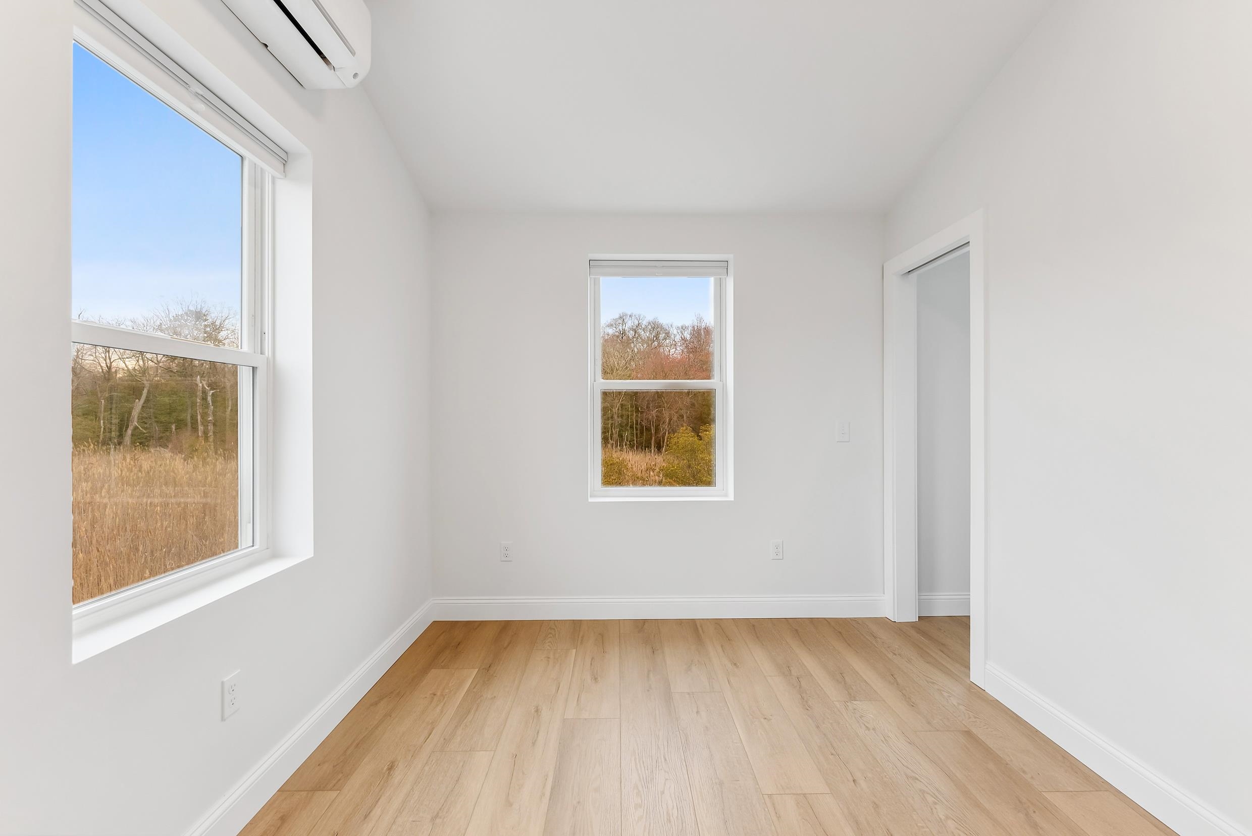 22 Moores Beach Road Delmont, NJ 08314 - Photo 9 of 18 a view of an empty room with wooden floor and a window
