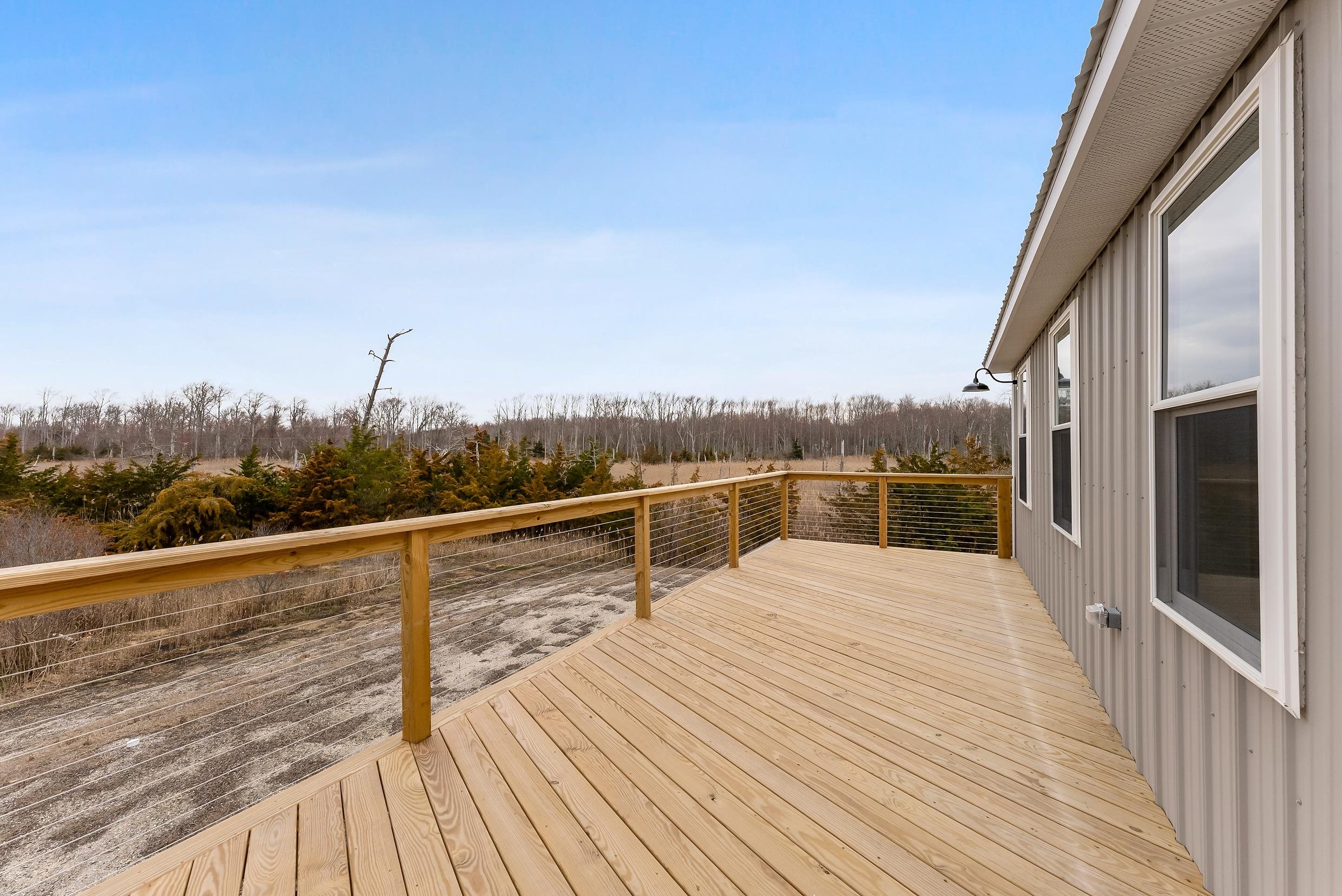 22 Moores Beach Road Delmont, NJ 08314 - Photo 10 of 18 a view of a balcony with mountain view and wooden floor