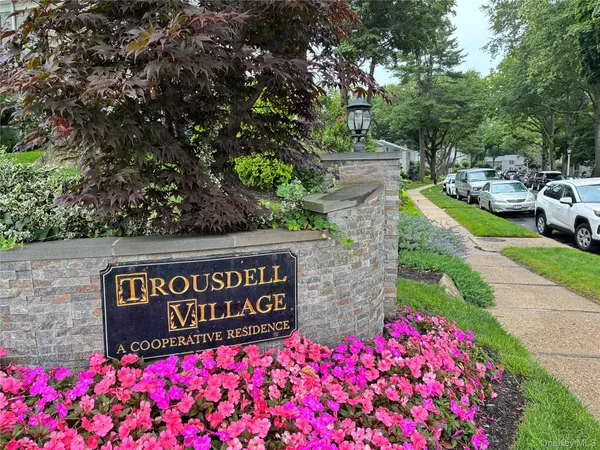 a sign that is sitting in front of flowers
