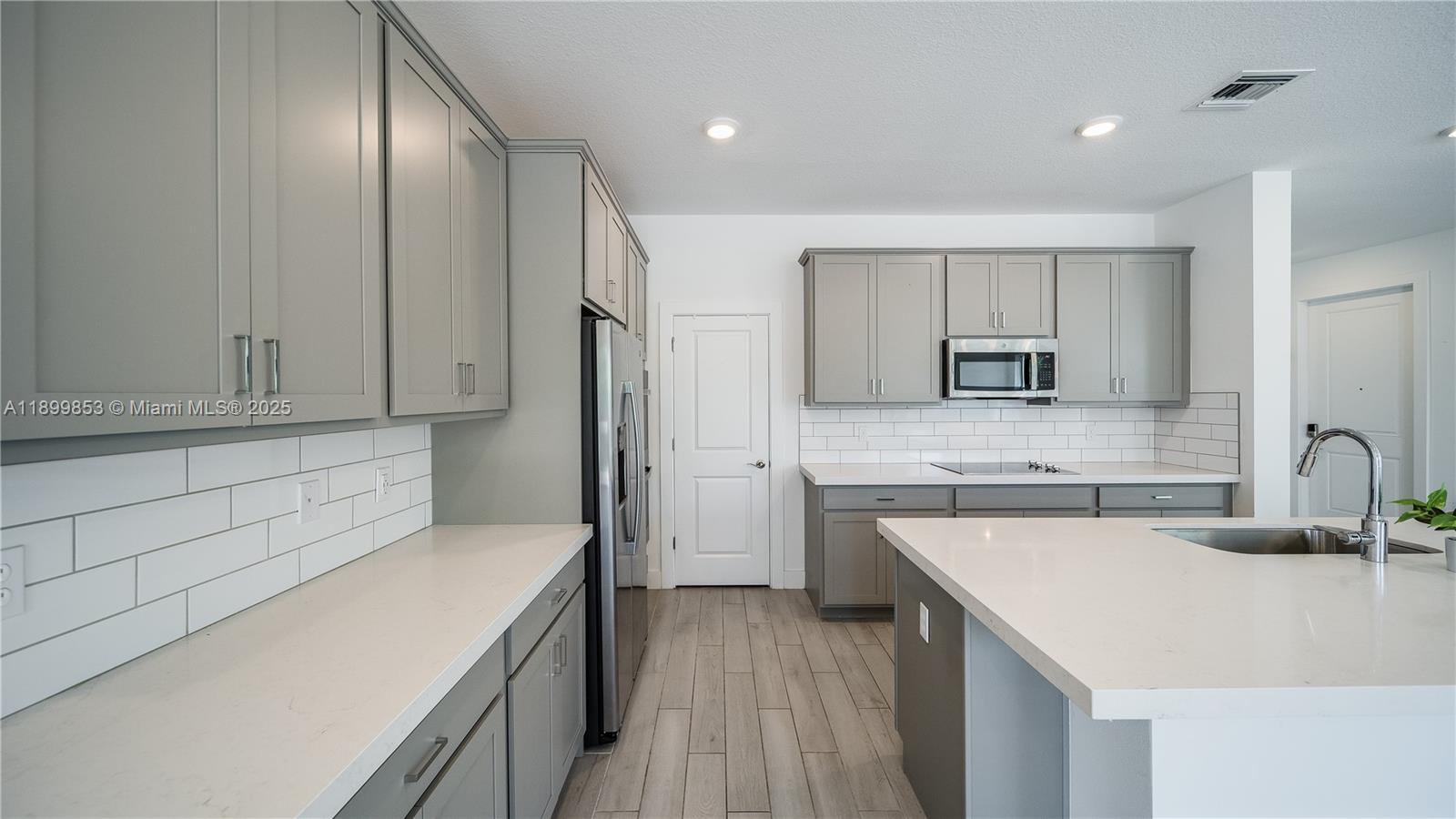241 Preserve Trail North Stuart, FL 34994 - Photo 13 of 37 a kitchen with a sink a stove a refrigerator and cabinets