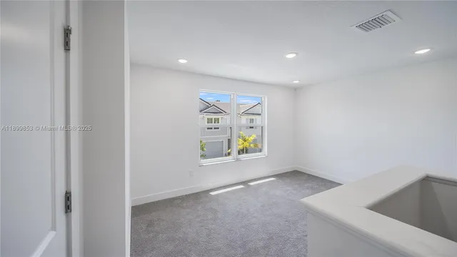 a view of an empty room and a window