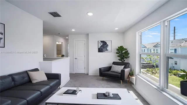 a living room with furniture and a large window