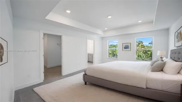 a bedroom with a large bed and a window