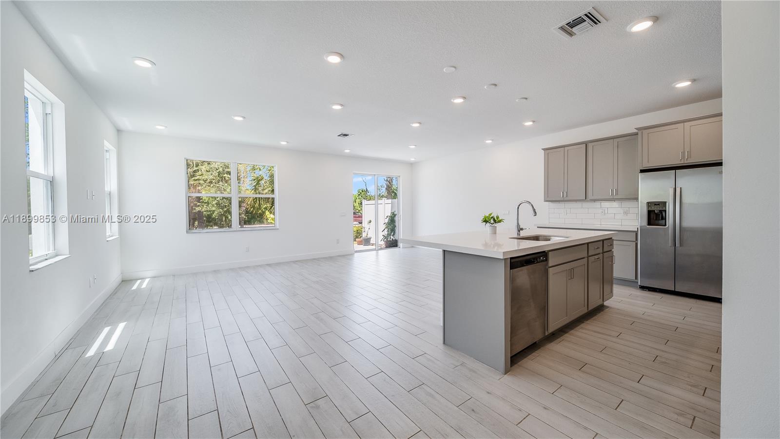 241 Preserve Trail North Stuart, FL 34994 - Photo 6 of 37 a large kitchen with stainless steel appliances granite countertop a large counter top a wooden floors and a large window