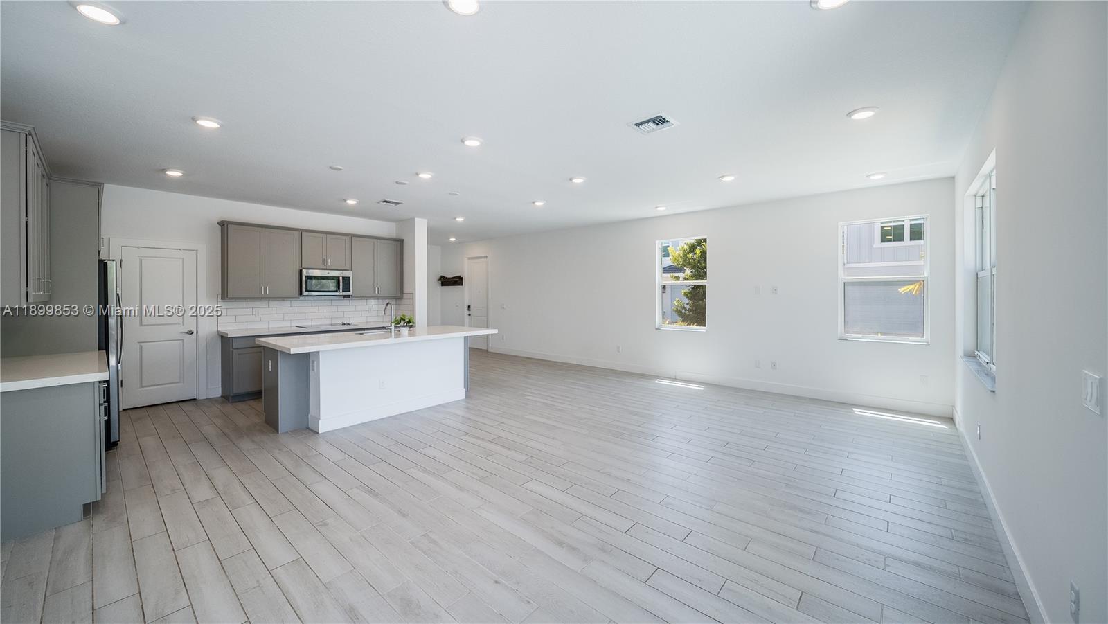 241 Preserve Trail North Stuart, FL 34994 - Photo 9 of 37 a large kitchen with stainless steel appliances kitchen island a large counter top and a stove top oven