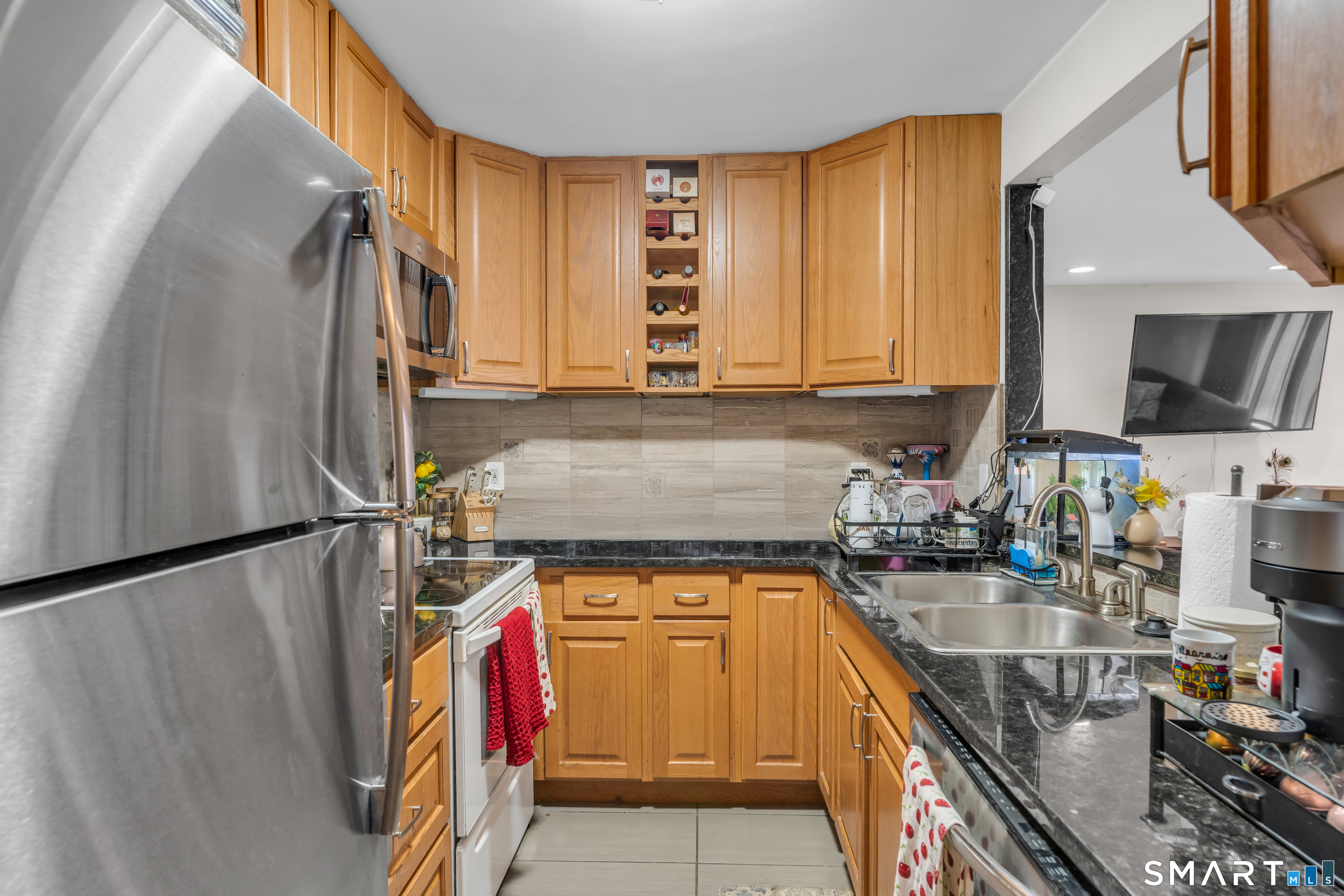 175 Mill Pond Road, Unit 444 Hamden, CT 06514 - Photo 11 of 38 a kitchen with stainless steel appliances granite countertop a sink a stove and a refrigerator
