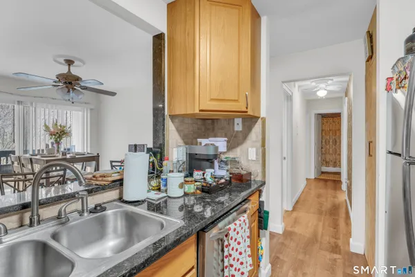 a kitchen with sink and mirror