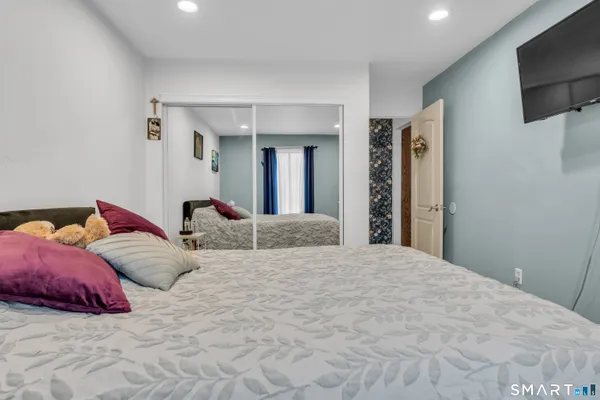 a bedroom with a bed and a flat screen tv