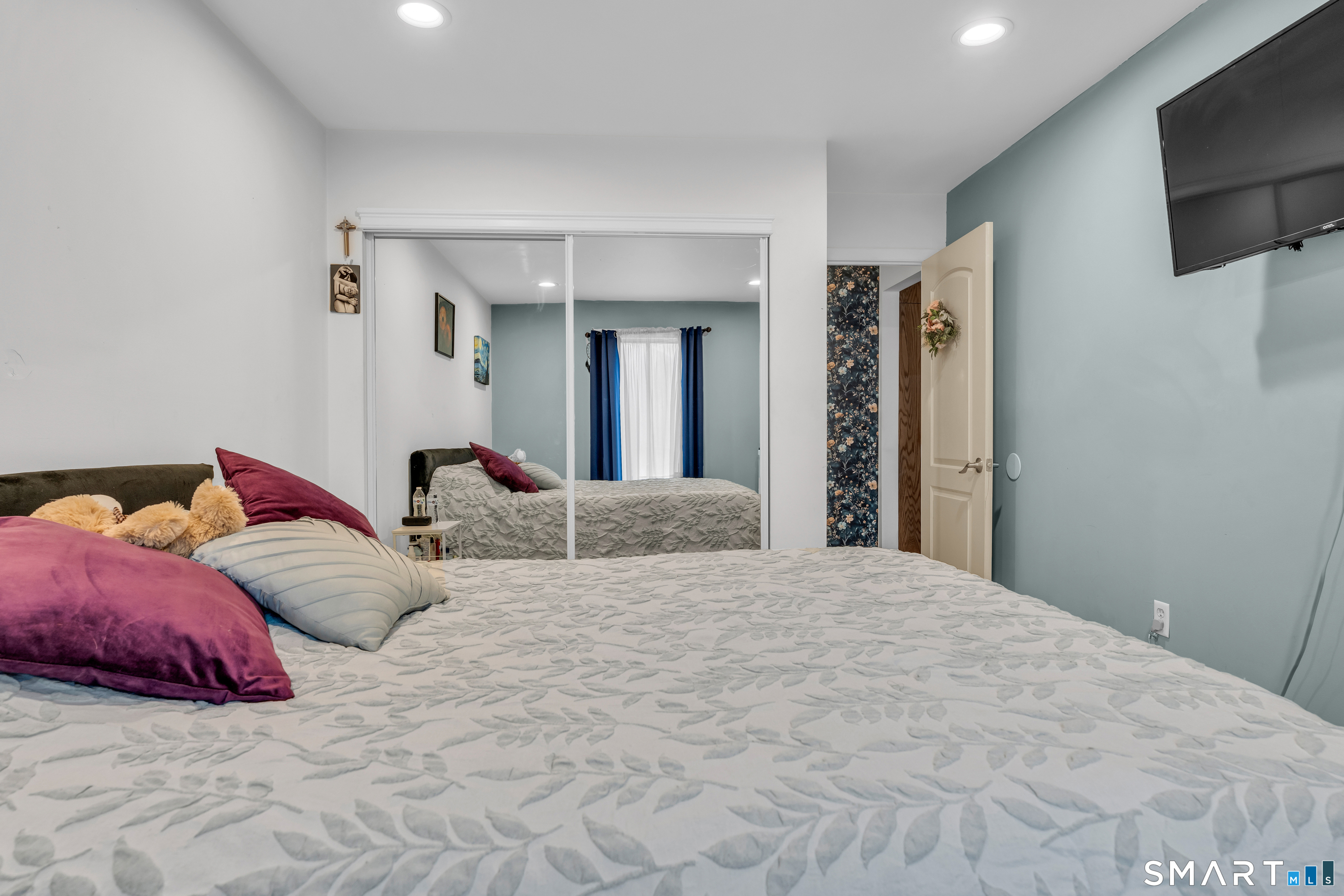 175 Mill Pond Road, Unit 444 Hamden, CT 06514 - Photo 16 of 38 a bedroom with a bed and a flat screen tv