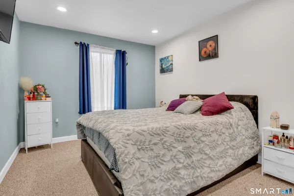 a bedroom with a bed and a dresser