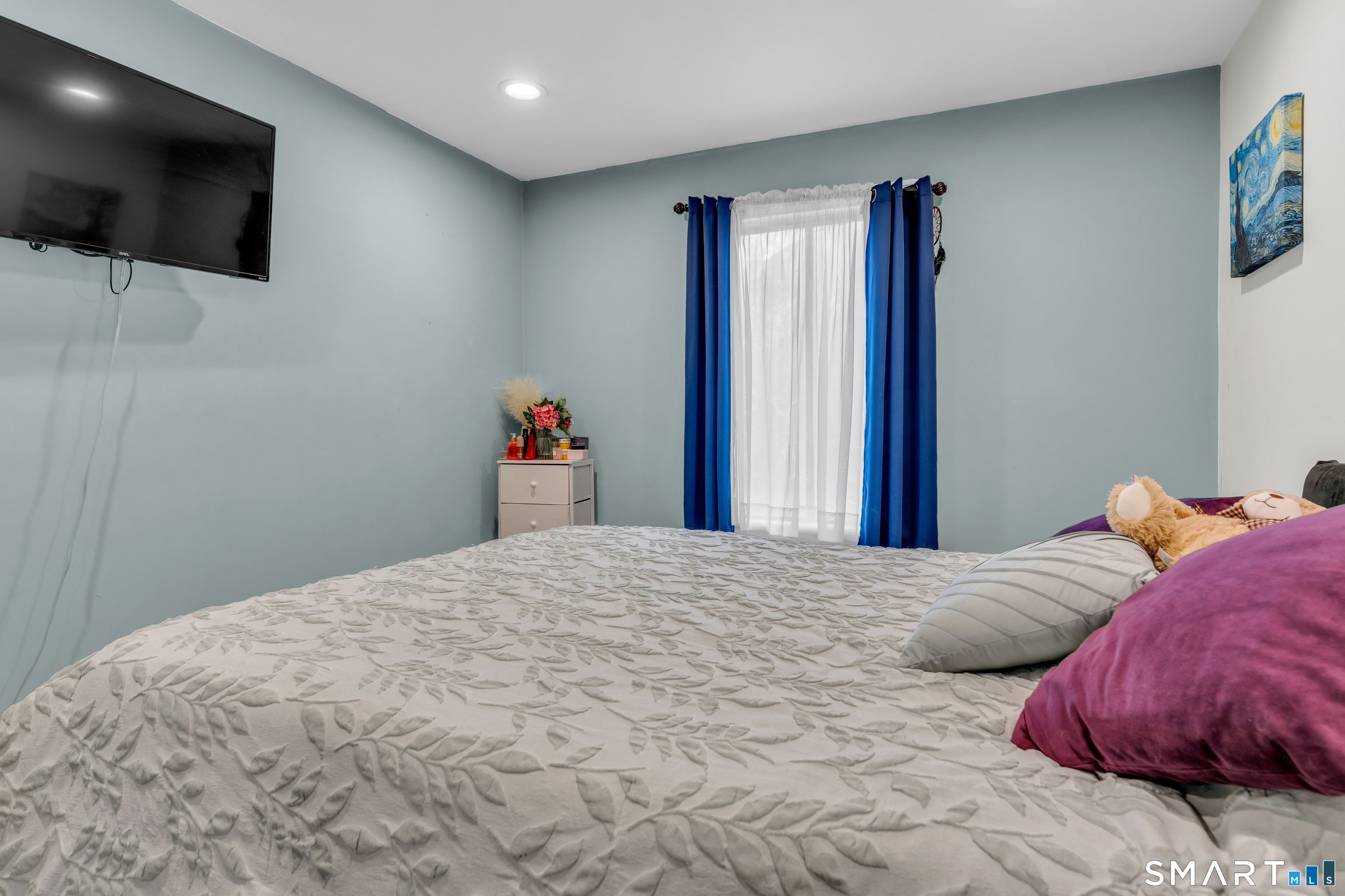 175 Mill Pond Road, Unit 444 Hamden, CT 06514 - Photo 18 of 38 a bedroom with a bed and a flat screen tv