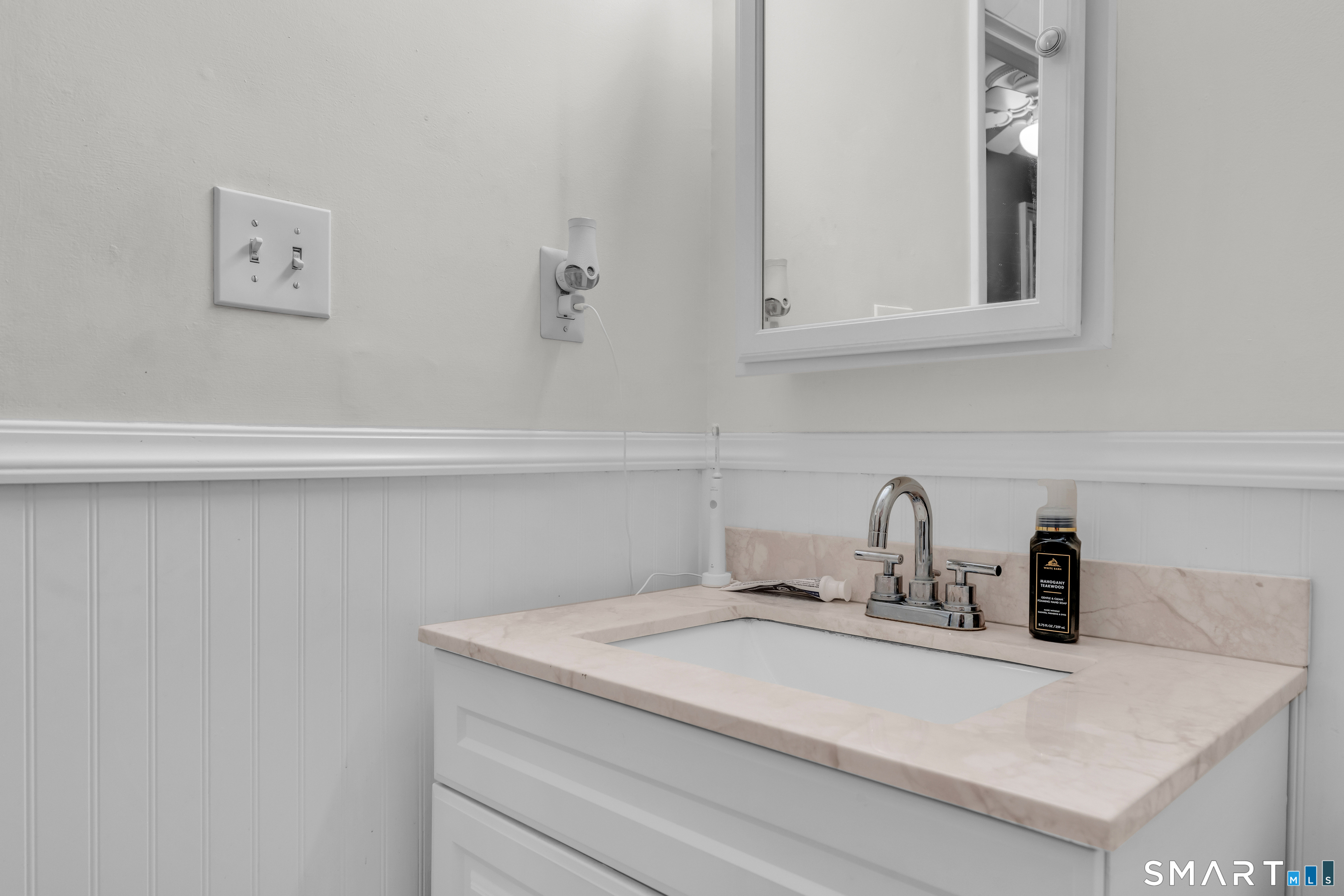 175 Mill Pond Road, Unit 444 Hamden, CT 06514 - Photo 19 of 38 a bathroom with a sink and a mirror