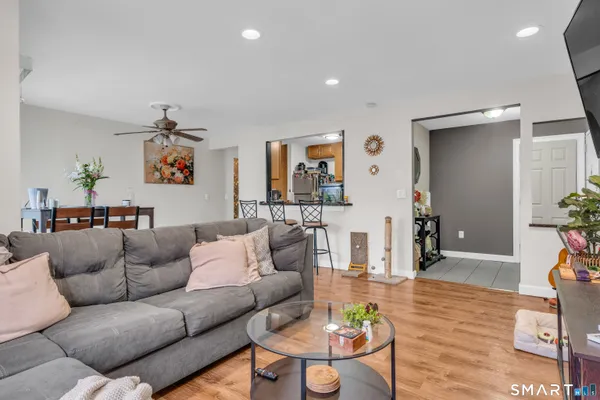 a living room with furniture and wooden floor