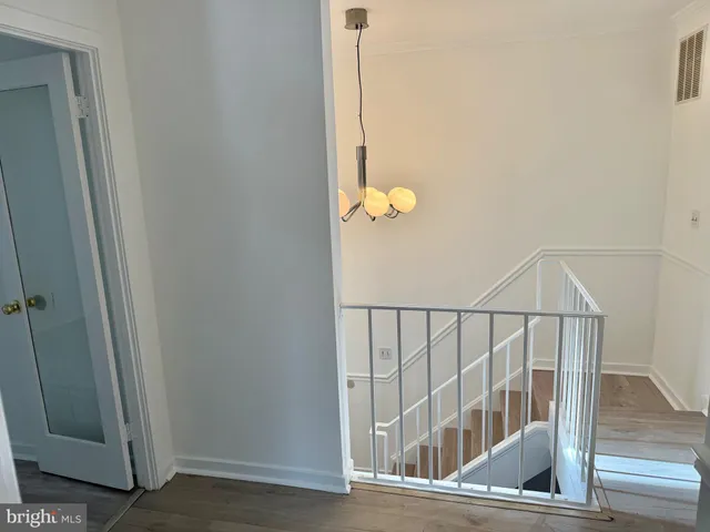 a view of staircase with white walls and a window