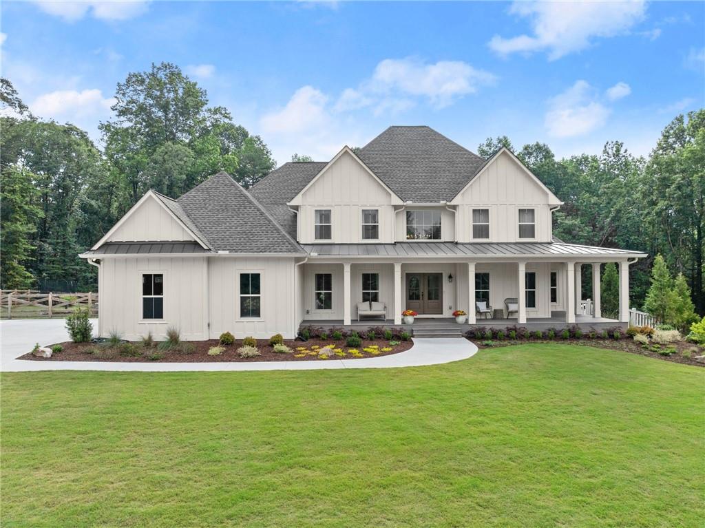 6998 Britt Gailey Road Clermont, GA 30527 - Photo 84 of 92 a front view of a house with garden and trees