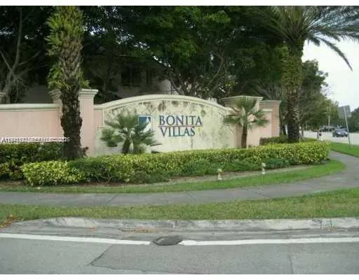 a close view of a sink and dishwasher with kitchen island