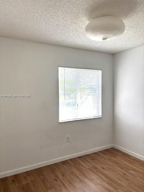 14045 Southwest 121st Place, Unit 524 Miami, FL 33186 - Photo 36 of 46 an empty room with wooden floor and windows