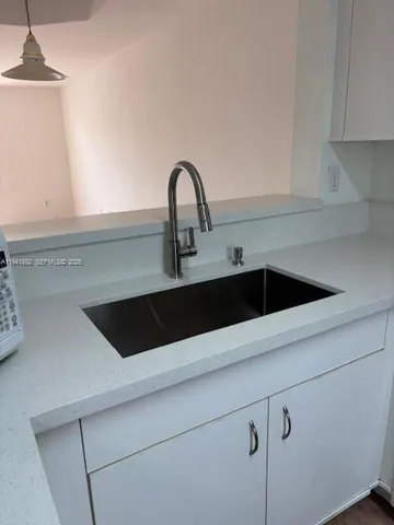 a kitchen with a sink and a window