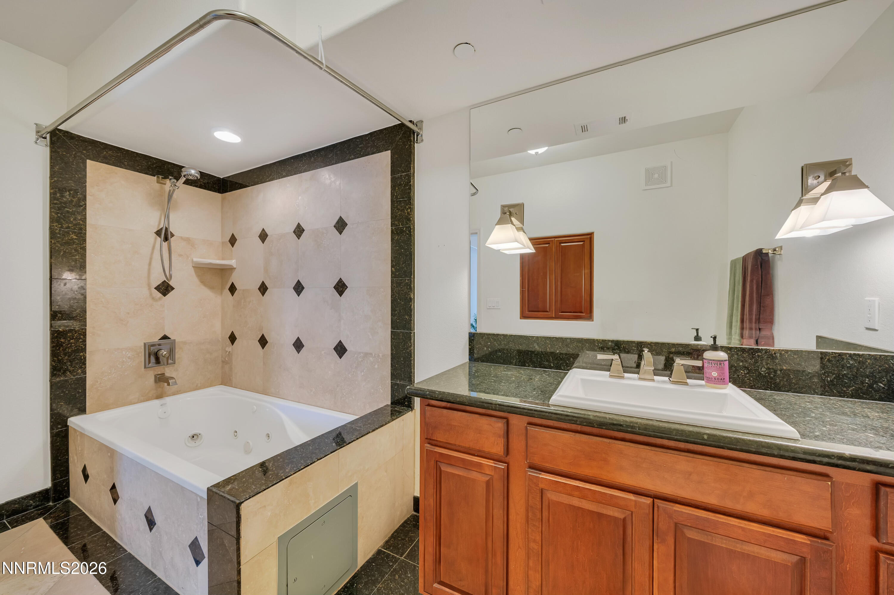 200 West 2nd Street, Unit 705 Reno, NV 89501 - Photo 8 of 11 a bathroom with a sink vanity granite and a mirror