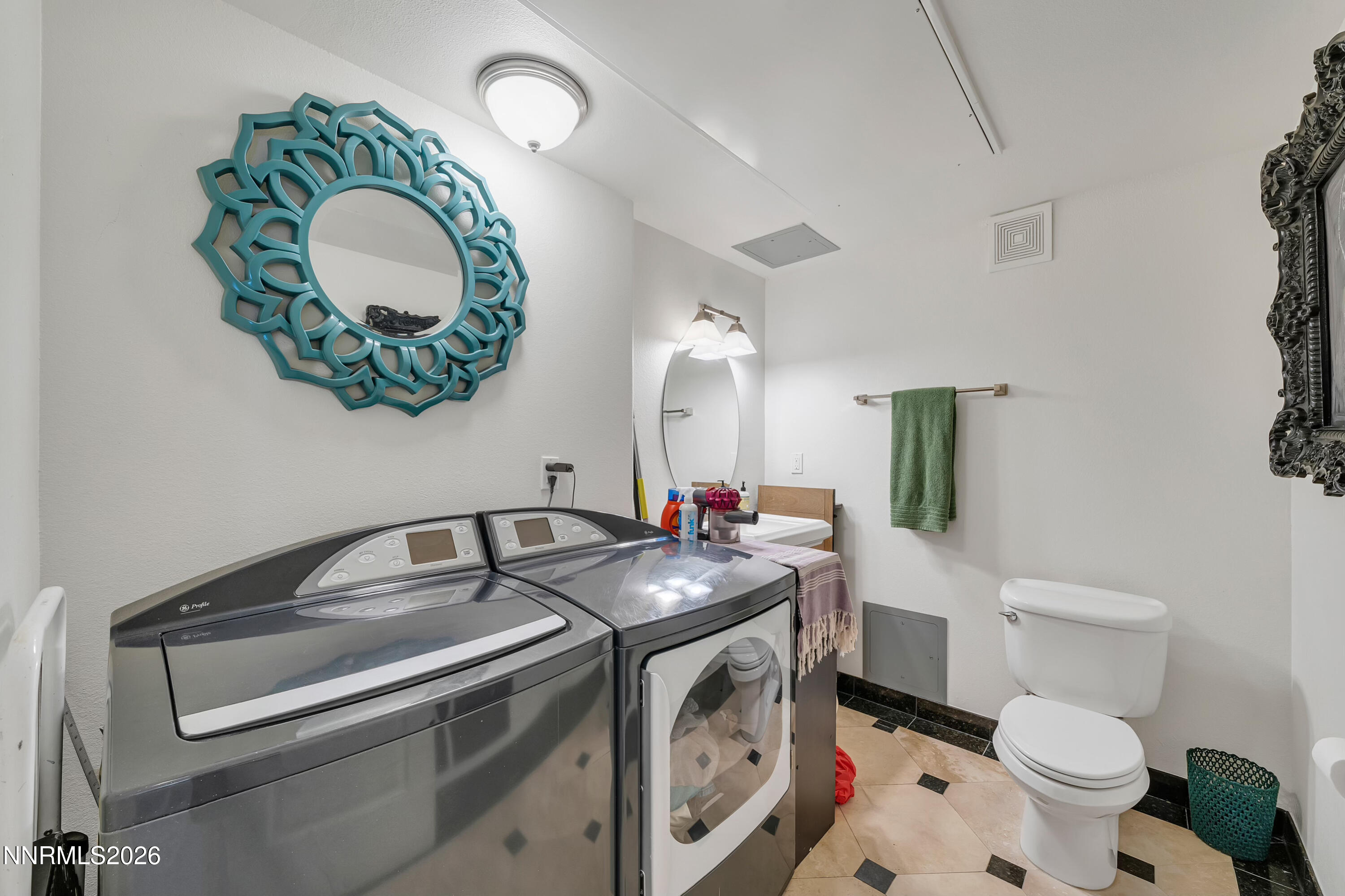 200 West 2nd Street, Unit 705 Reno, NV 89501 - Photo 9 of 11 a bathroom with a toilet a sink and a mirror
