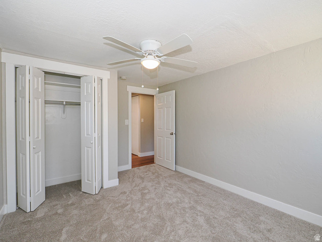154 East 3000th Street South Bountiful, UT 84010 - Photo 18 of 37 Carpeted room featuring a ceiling fan with integrated lighting, bi-fold closet doors, white baseboards, and a white interior door