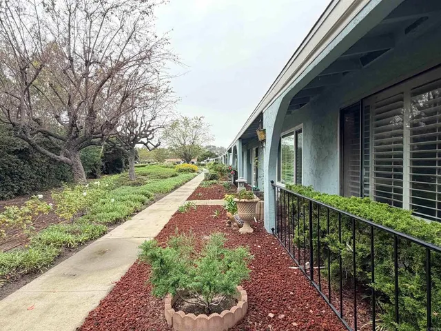 a view of a pathway of a house with a yard