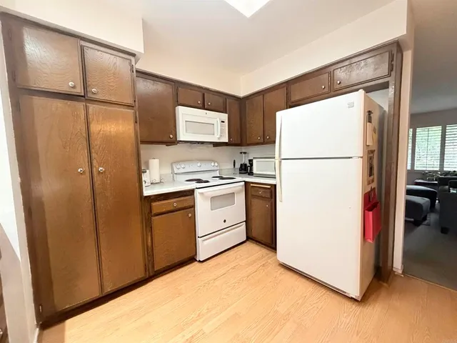 a kitchen with a refrigerator sink stove and cabinets