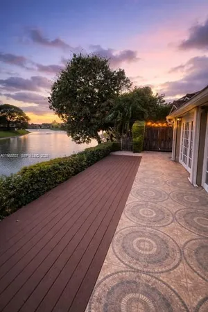a view of balcony with wooden floor and lake view