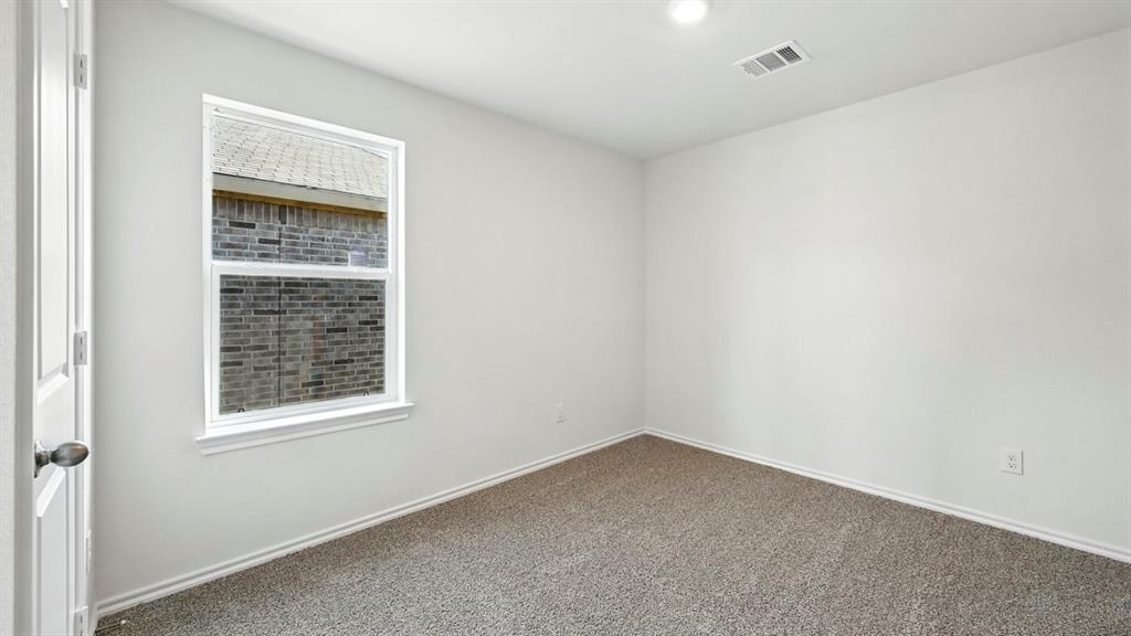 122 Pheasant Run Road Terrell, TX 75160 - Photo 11 of 36 Interior room featuring neutral wall paint, carpet flooring, a single window, and a ceiling-mounted light fixture